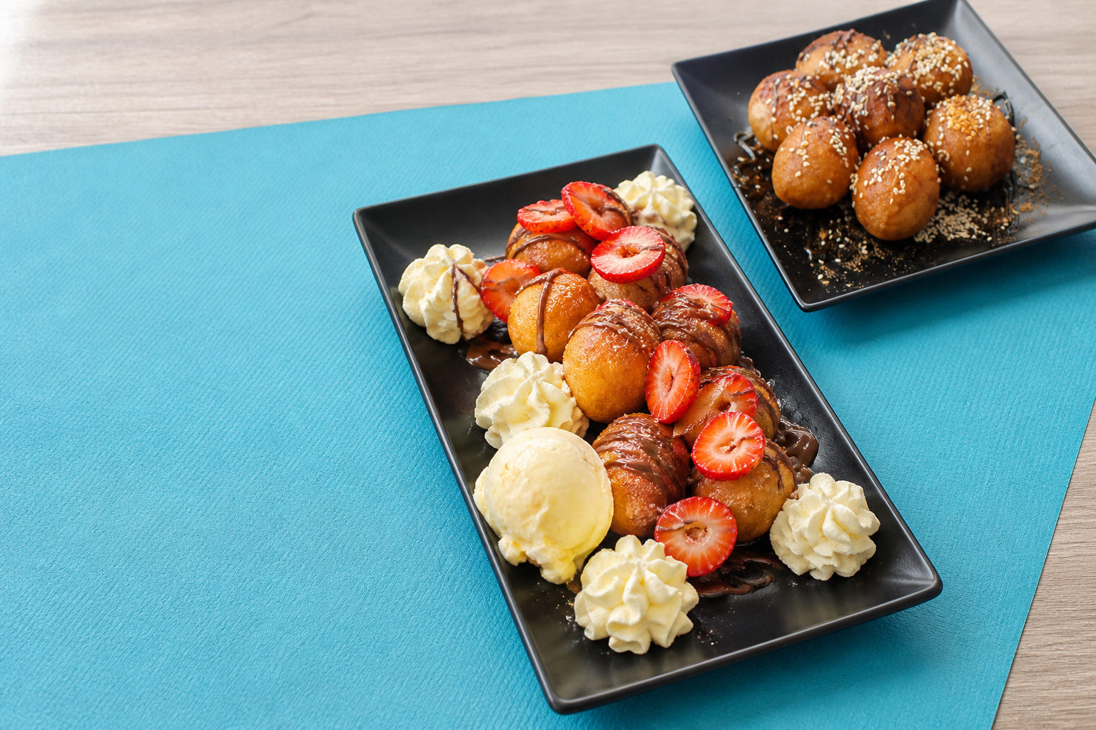 Loukoumades served with strawberry, chocolate and cream